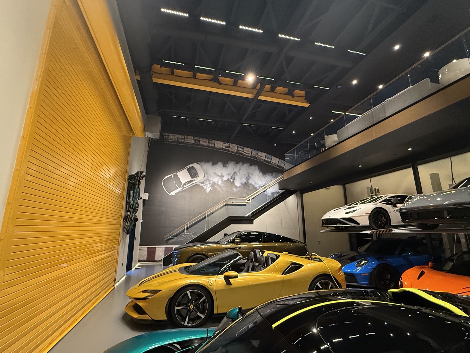 Ferrari SF90 Spider below the burnout mural