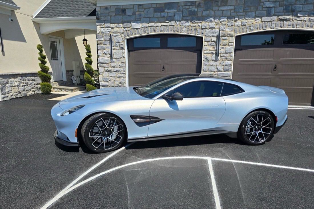 Aston Martin Vanquish in silver outside the garage